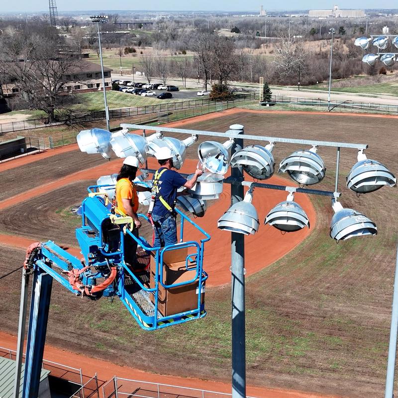 McElroy Electric electricians use an 80-foot lift to replace ball-diamond lighting at Hummer Sports Park, in Topeka.