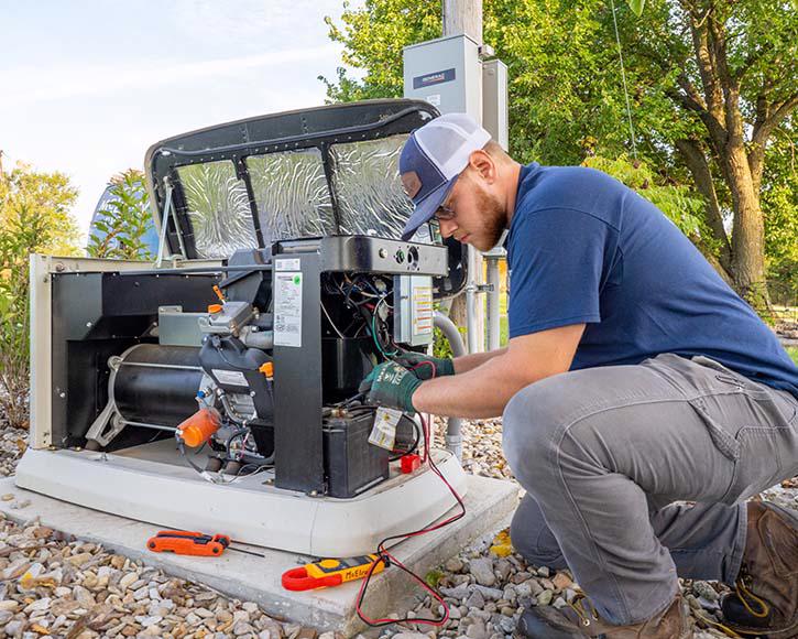 A McElroy Electric electrician performs diagnostics on a Generac generator.