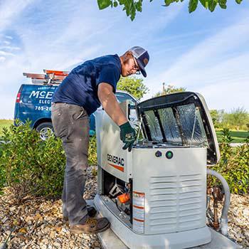 A McElroy Electric electrician completes scheduled maintenance on a Generac generator.