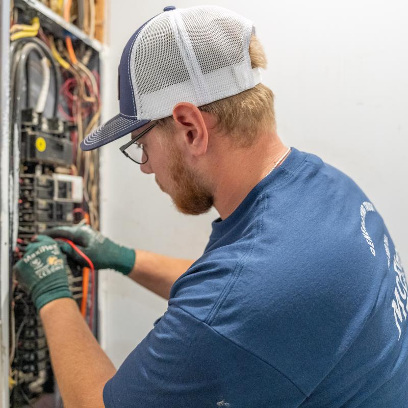 A McElroy Electric electrician tests a residential circuit breaker cabinet.