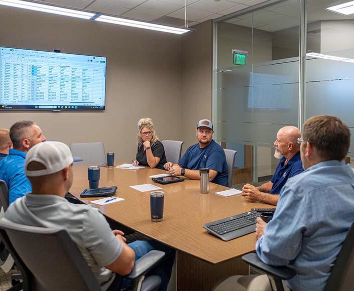 The McElroy Electric leadership team discusses projects.