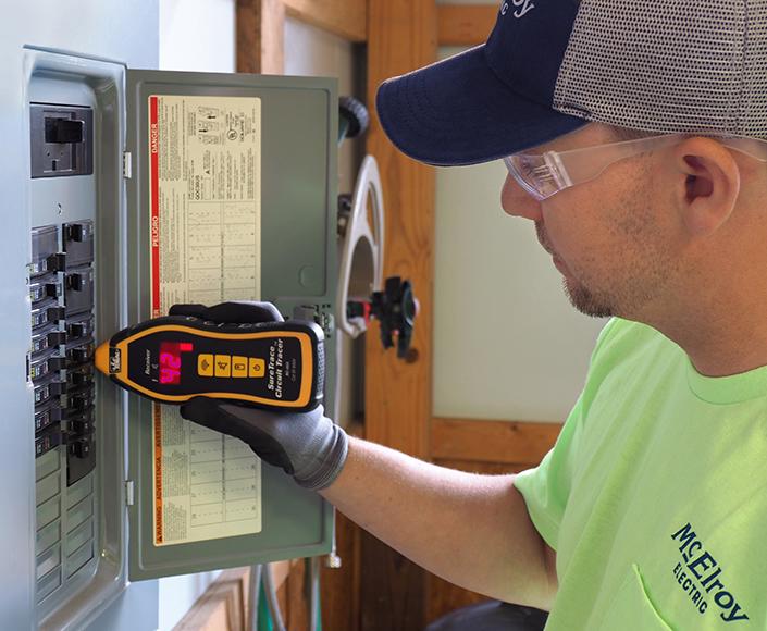 McElroy Electric electrician checks a fuse box for faults.