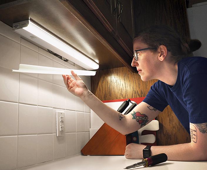 McElroy Electric electrician installs under-cabinet kitchen lighting.