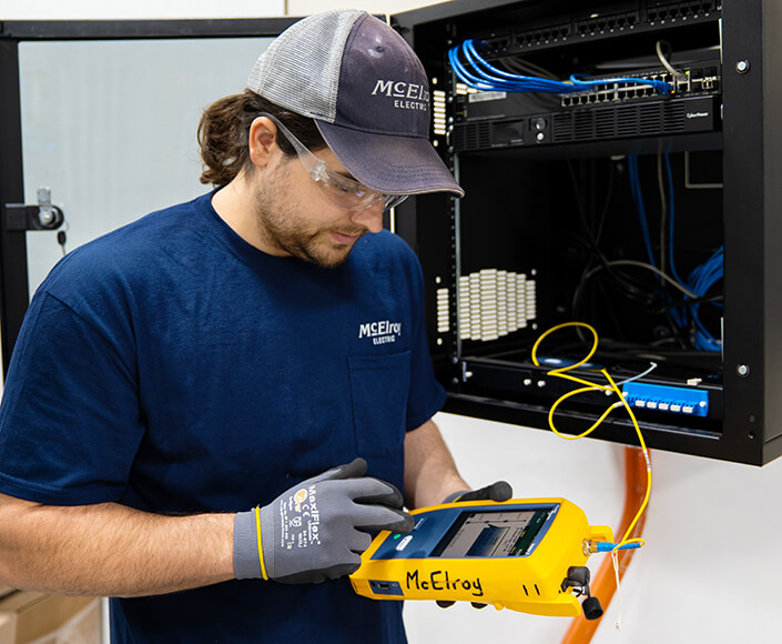  McElroy Electric electrician uses OTDR technology to test fiber optic cable.