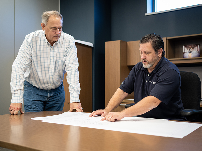 Jerry Hansen and John Hoover, McElroy Electric estimator review customer project plans.