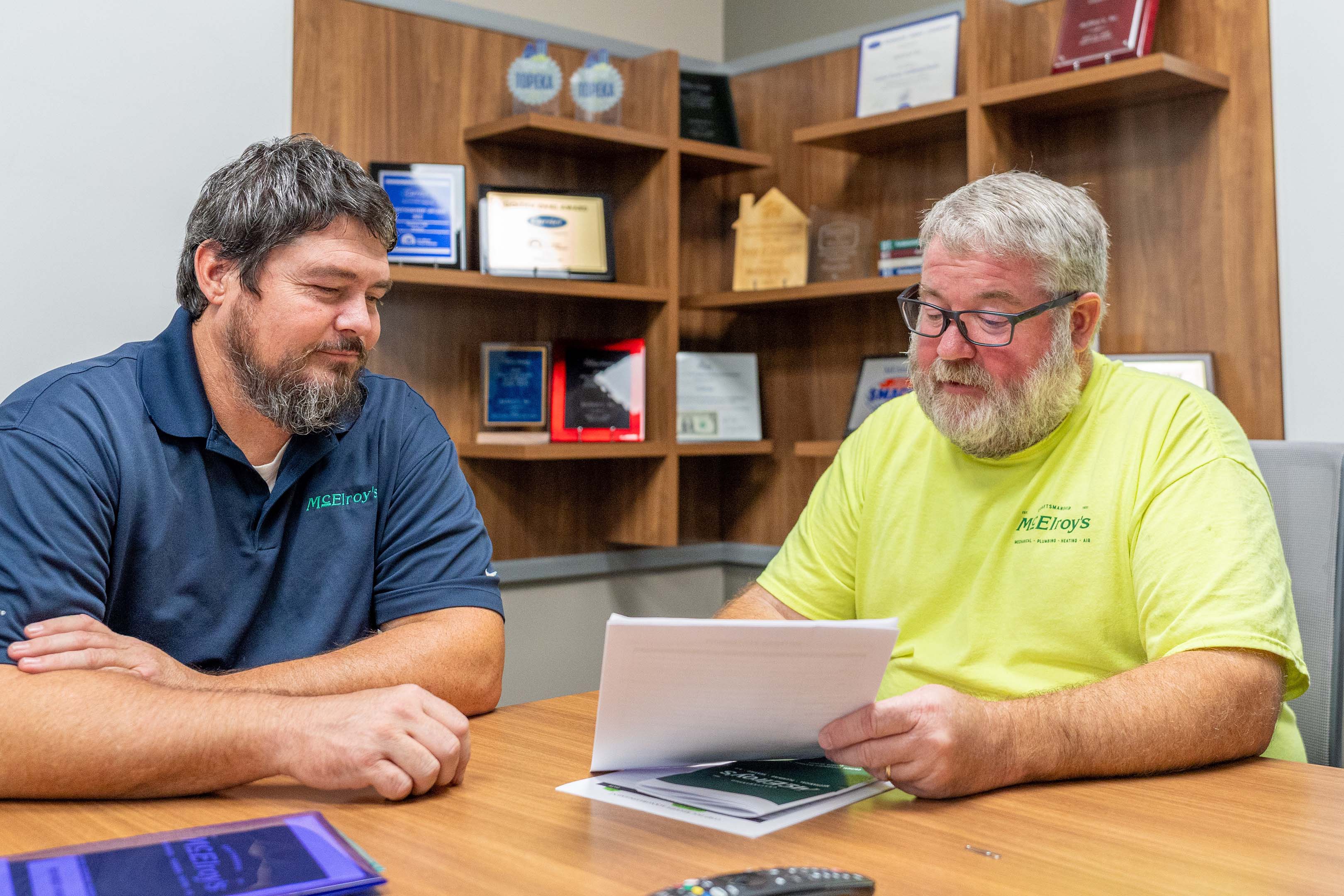 Shawn O’Malley, McElroy Electric safety manager, reviews safety matters with Luke Dumler, McElroy’s plumbing service manager.