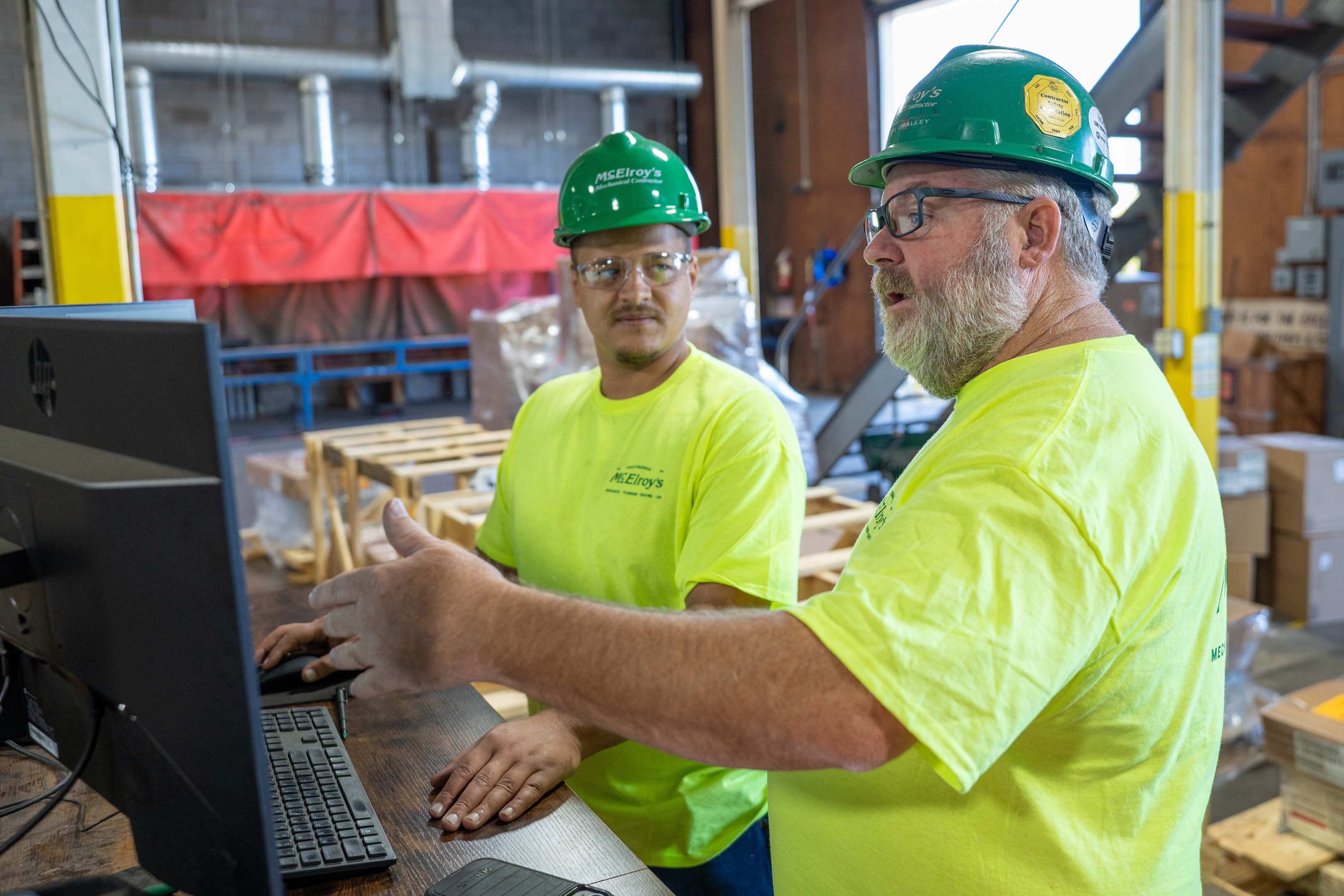 Shawn O’Malley, McElroy Electric safety manager, discusses safety matters with a construction technician on the jobsite.
